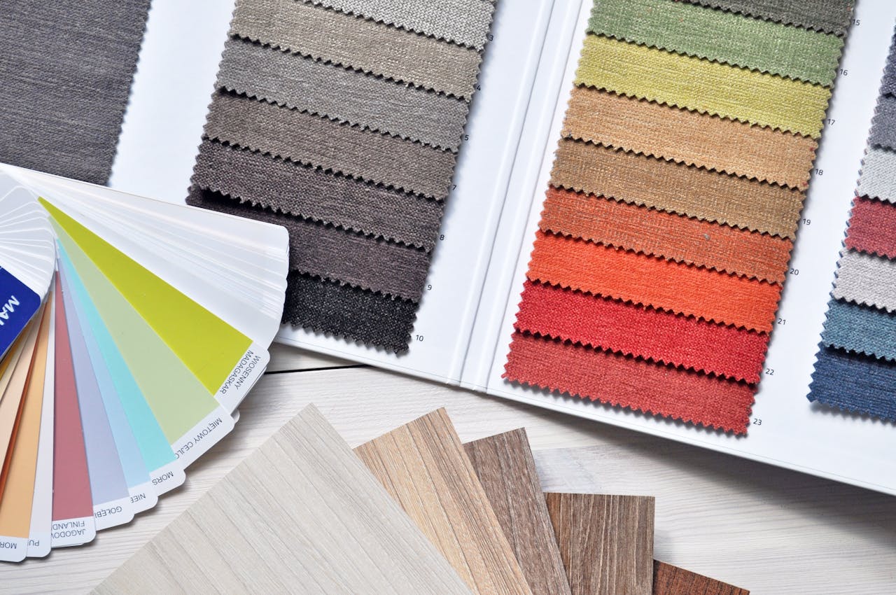 why-choose-us Colorful fabric and paint swatches laid out for design inspiration and material selection.