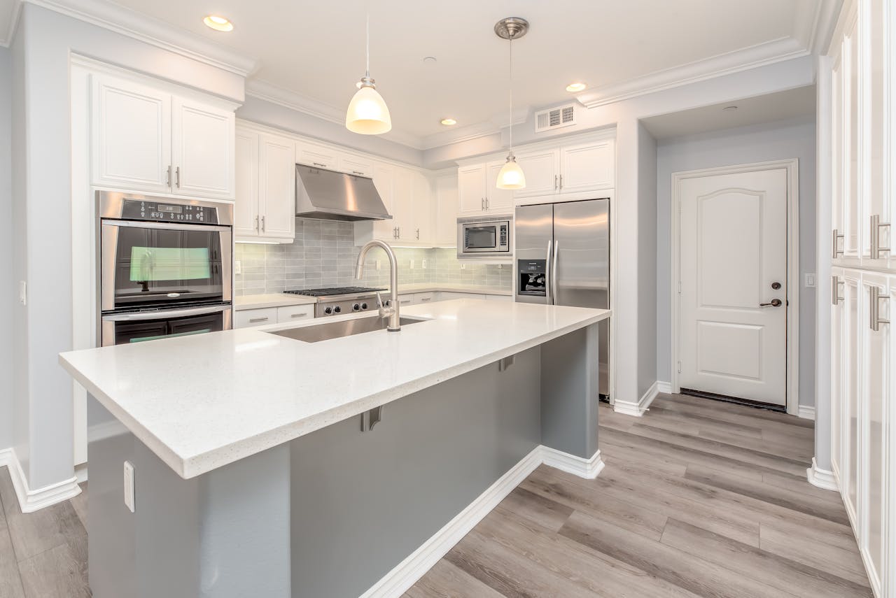 gallery-3 Modern kitchen interior featuring sleek white cabinetry and stainless steel appliances.